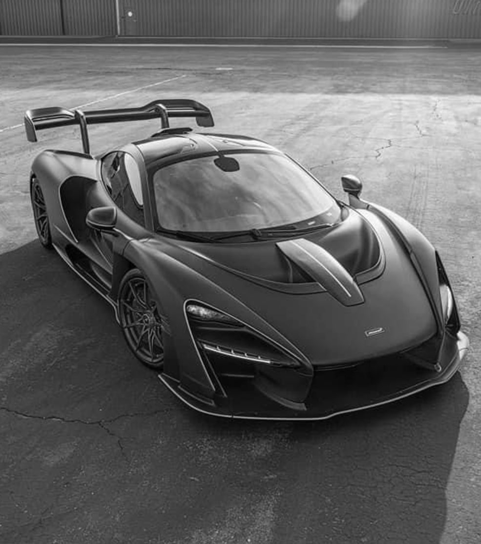 Sports Car WHOLESALECHAD a-green-sports-car-parked-on-the-side-of-a-building